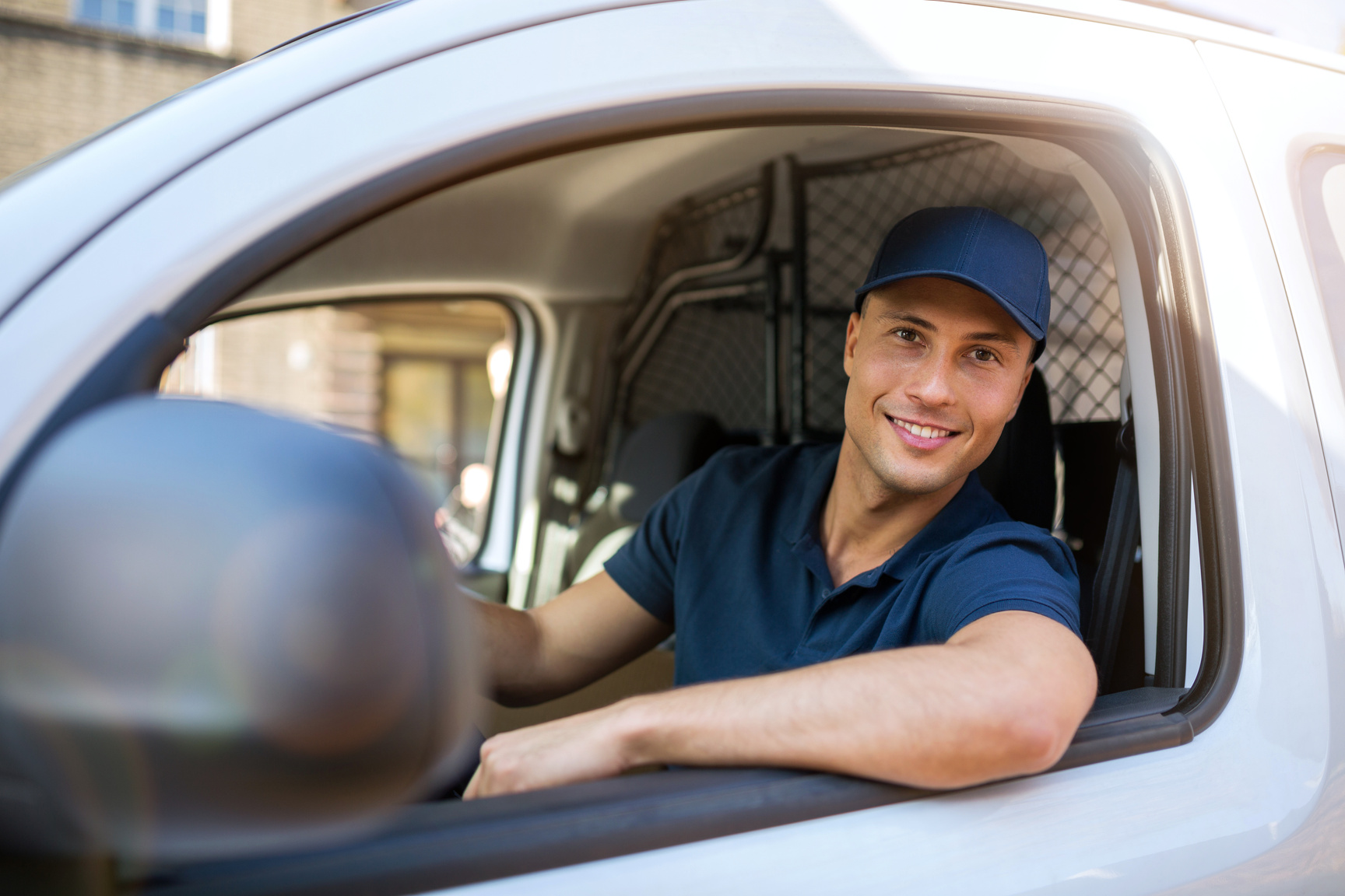 Delivery man sitting in a delivery van